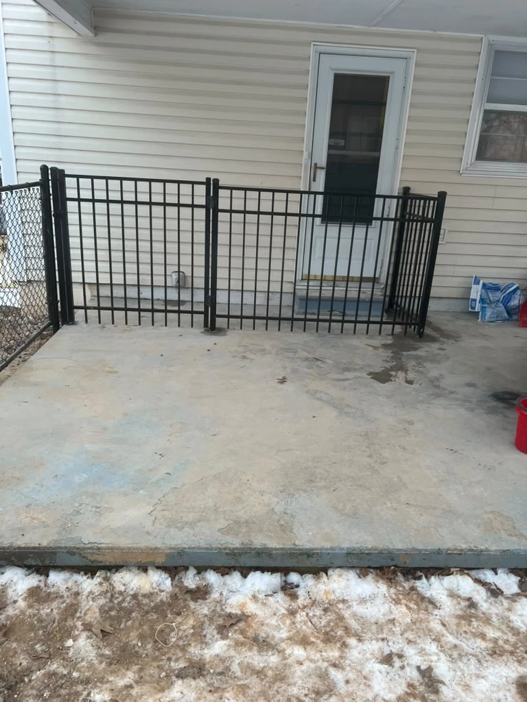 Black metal gate and fencing around a patio entrance