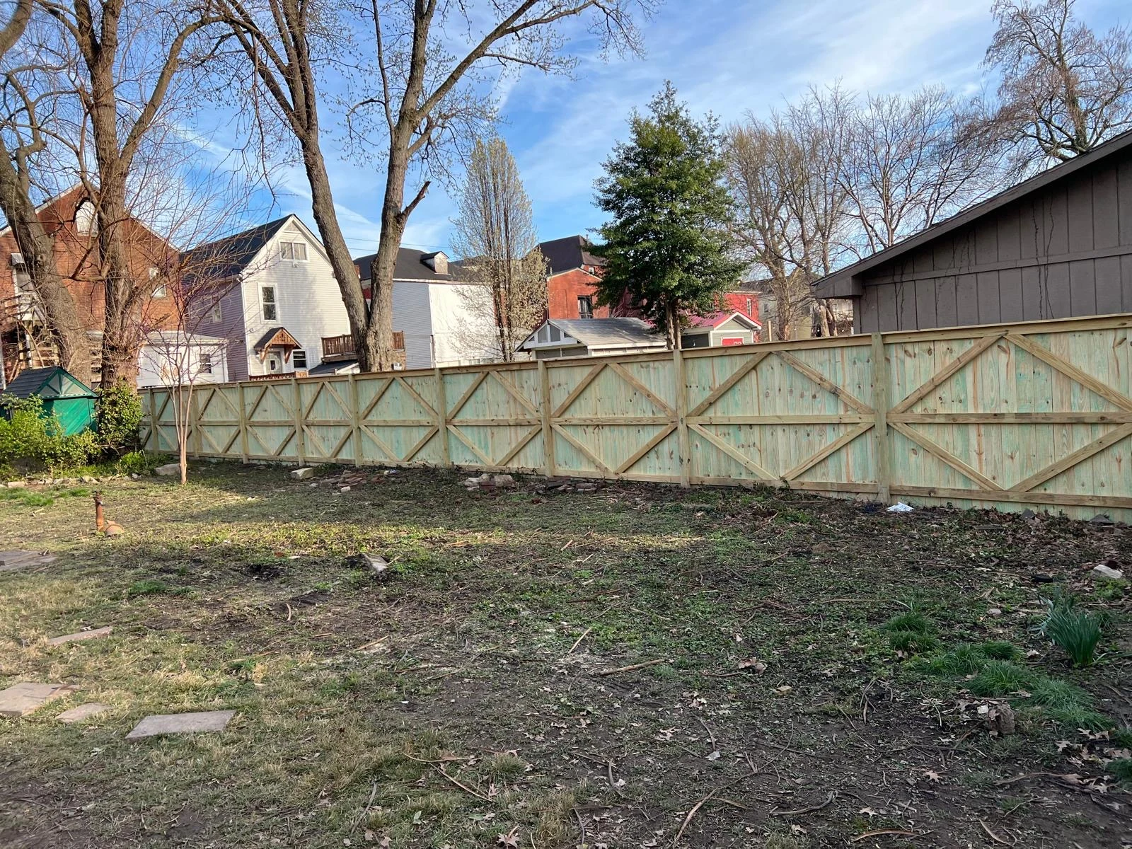 Wood fence with cross-braced rails